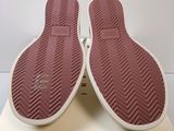 the bottom of a pair of pink slippers on a white box