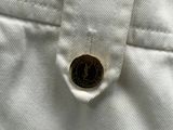 a button on the back of a pair of white pants