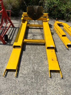 a close up of a fork lifter sitting on top of a cement ground