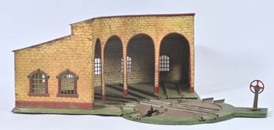 une maquette de gare avec un panneau « Stop » devant