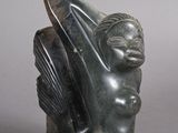 statue of a woman with a bird on her head