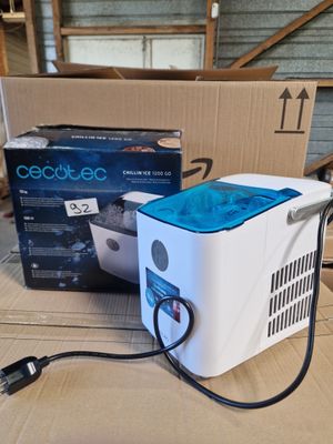 a white and blue cooler sitting on top of a cardboard box