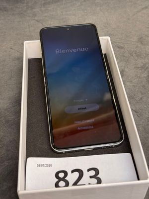an iphone is sitting in a box on a table with a price tag on it