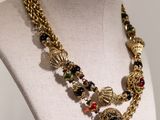 a close up of a necklace on a mannequin on a display