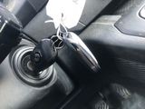 a close up of a car ' s gear lever with a tag attached to it