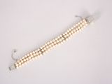 bracelet with white pearls and silver clasp on a white background