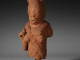 a clay statue of a woman holding a baby in her arms