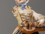 a figurine of a woman holding a guitar