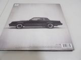 an old photo of a black car on a white table