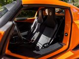 an orange sports car with black seats in the back