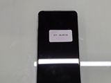 a black cell phone with a sticker on it