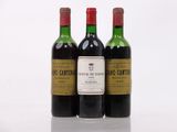 three bottles of wine sitting next to each other on a white surface