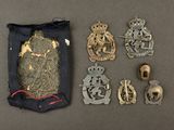 an assortment of military badges and other items on a table
