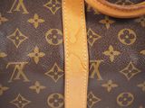 a close up of a brown and tan louis vuitton bag