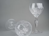 three wine glasses sitting next to each other on a table