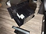 a broken laptop computer sitting on the floor next to a ruler
