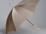 an open umbrella with a wooden handle on a gray background
