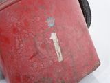 a red suitcase sitting on top of a white surface