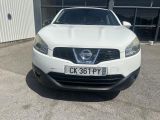 the front of a white nissan qx parked in front of a building