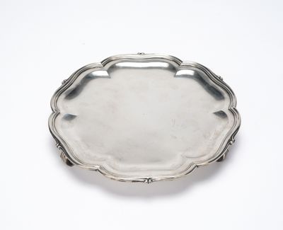 a silver tray with a handle on a white surface