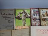 several books are stacked on top of each other on a shelf