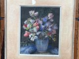 une photo d'un tableau représentant des fleurs dans un vase, posé sur un chevalet