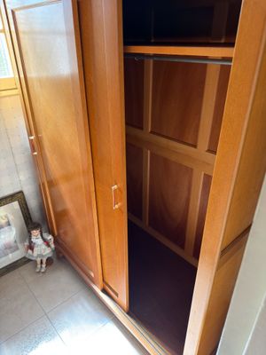 a wooden cabinet with a tv on top of it
