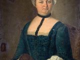 portrait of a woman in a blue dress holding a dog