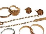 a lot of different rings and bracelets on a white background