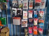 a wall with many different items on it in a store