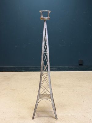 an image of a tall metal tower with a basket on top of it