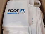 a cardboard box with a bunch of white bags inside of it