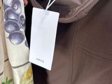 a person holding a bag with a tag attached to it
