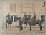 an old photo of a group of men on horses