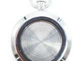 a close up of a pocket watch on a white surface