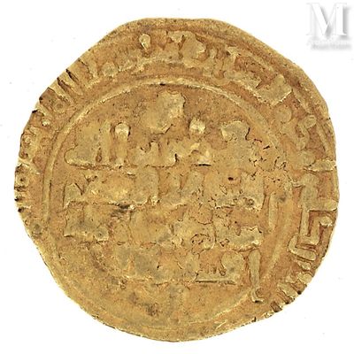a close up of a gold coin on a white surface