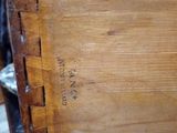 a piece of wood that is sitting on a chair