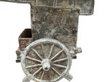 a small wooden cart with a cannon on top of it