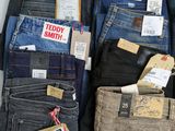 several pairs of men ' s jeans are on display in a store