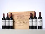 three bottles of red wine in front of a wooden box