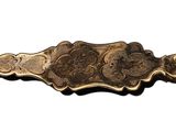 a gold plate with a flower design on it