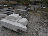 a pile of concrete blocks on the ground in a cemetery