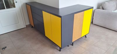 a yellow and grey cabinet in a living room