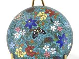an image of a blue plate with a butterfly and flowers on it
