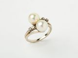 a white pearl and diamond ring on a white background