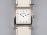 a close up of a wrist watch with a white leather strap