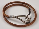 brown leather bracelet with a silver hook on a white background