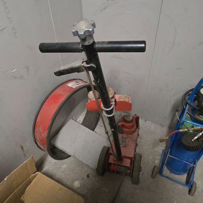 a scooter that is sitting next to a blue cart