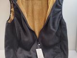 the jacket is hanging on a hanger with a tag on it