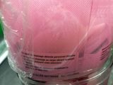 a bag of pink cotton candy sitting on top of a table